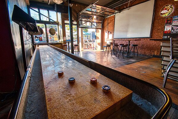 A wooden table with three small bowls on it.