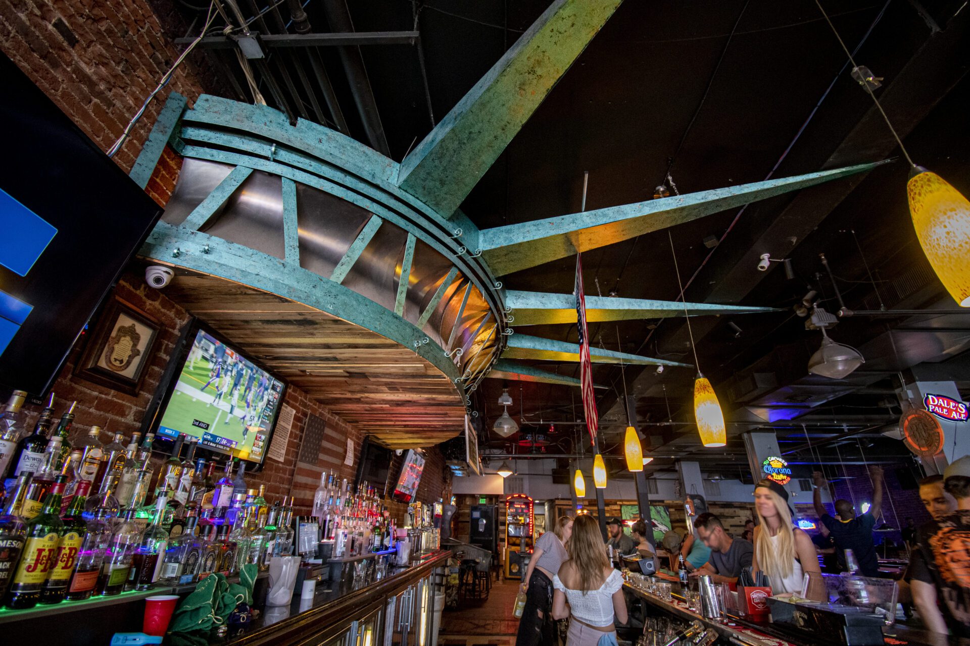 A bar with people standing at the counter